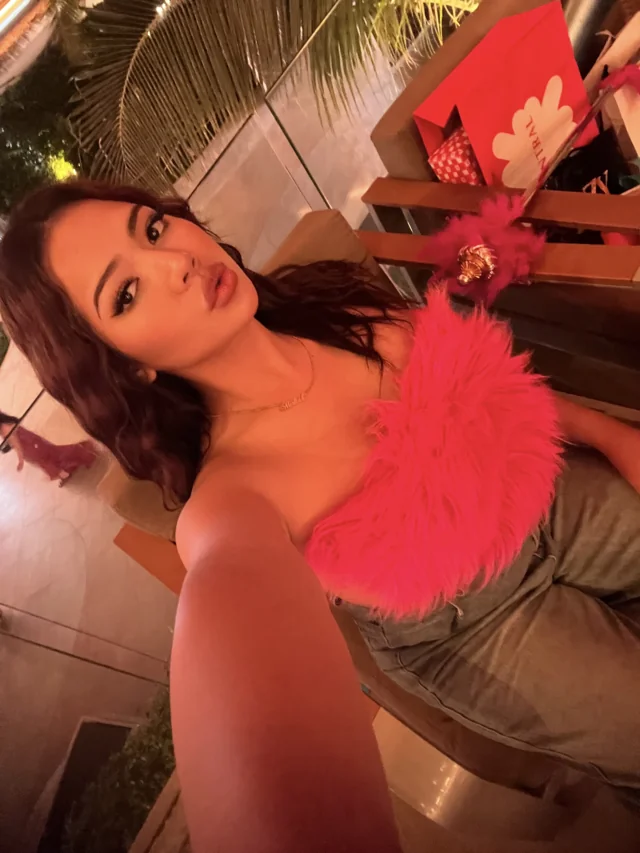 Josy wearing a vivid pink top on an evening out